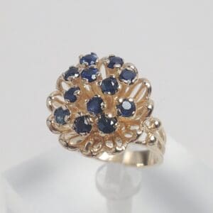 Gold ring with blue gemstones cluster.