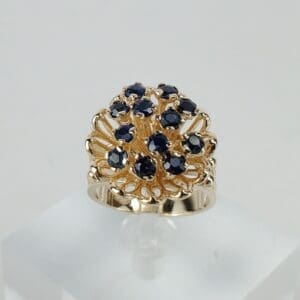Gold ring with dark blue gemstones.