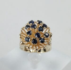 Gold ring with blue gemstone cluster design.