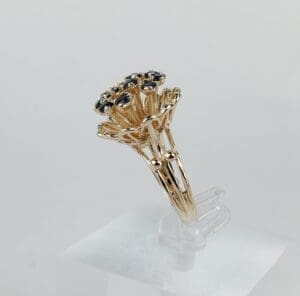 Ornate gold ring with blue gemstones.