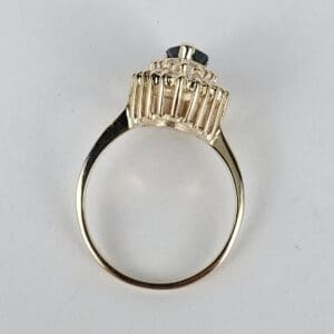 Gold ring with black gemstone setting.