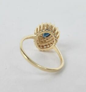 Gold ring with a blue gemstone centerpiece.