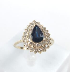 Gold ring with sapphire and diamond setting.