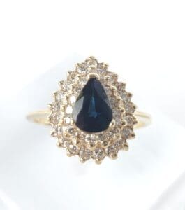 Gold ring with sapphire and diamond accents.