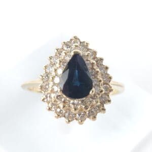 Gold ring with sapphire and diamond accents.