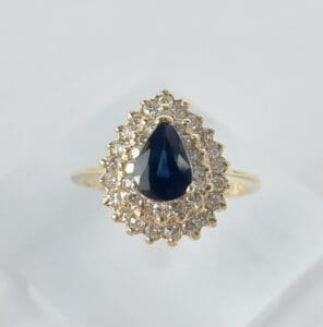 Gold ring with blue gemstone and diamonds.