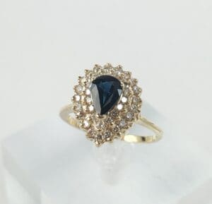 Gold ring with blue gemstone and diamonds.