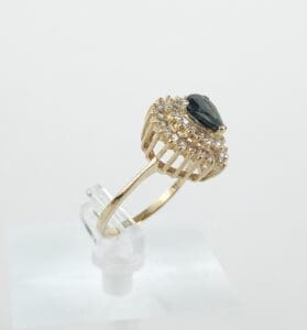 Gold ring with a dark gemstone centerpiece.