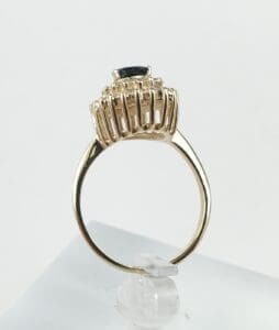 Gold ring with gemstone in prong setting.
