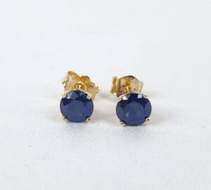 Blue gemstone stud earrings on display.