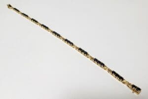 Gold and black gemstone bracelet on display.