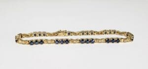 Gold bracelet with blue gemstones.
