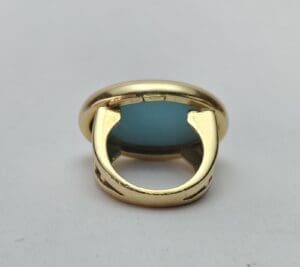 Gold ring with a blue gemstone.
