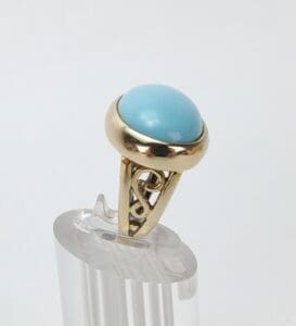 Gold ring with a blue gemstone.
