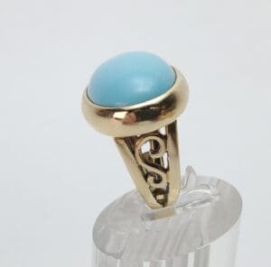 Gold ring with a blue gemstone.