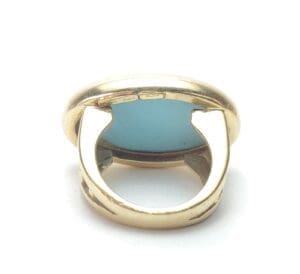 Gold ring with blue gemstone, rear view.