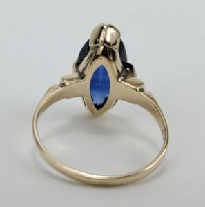 Gold ring with a blue gemstone.