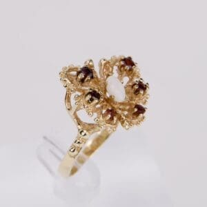 Gold ring with decorative gemstone design.