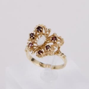 Gold ring with red and white gemstones.