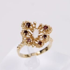 Gold ring with red and white stones.