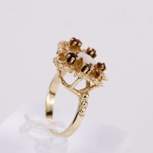 Gold ring with ornate gemstone setting.
