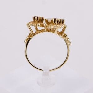 Gold ring with intricate crown-like setting.
