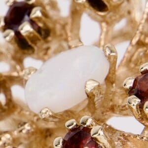 Gold ring with red and white gemstones.