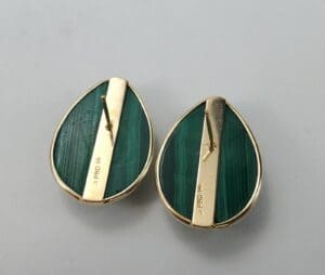Green teardrop earrings with gold accents.