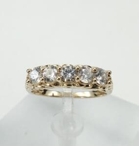 Gold ring with five sparkling diamonds.