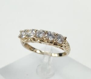 Gold ring with five sparkling diamonds.