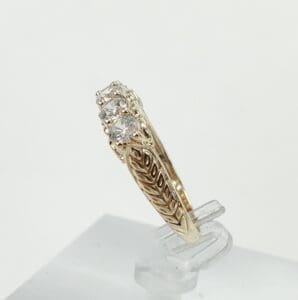 Gold ring with intricate design and diamonds.