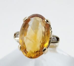 Oval amber gemstone ring with gold setting.