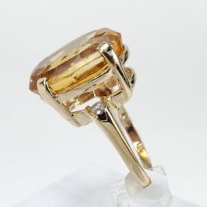 Gold ring with large amber gemstone.