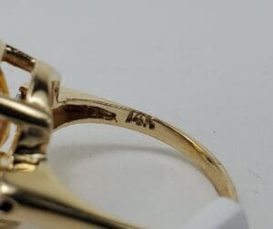 Gold ring with engraved metal stamp.