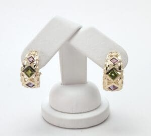Gold earrings with colorful gemstone accents.