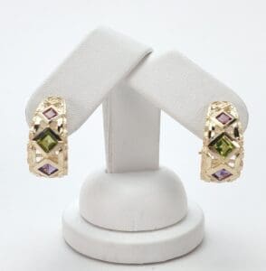 Gold earrings with colorful gemstone accents.
