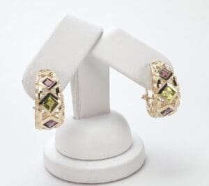 Gold earrings with colorful gemstone accents.