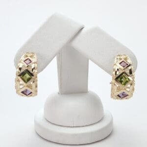 Gold earrings with colorful gemstone accents.