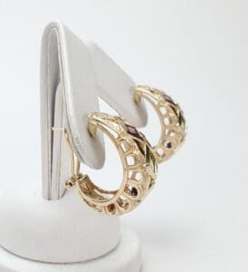 Gold hoop earrings with gemstone accents.