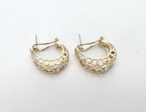 Gold hoop earrings with colorful gemstones.