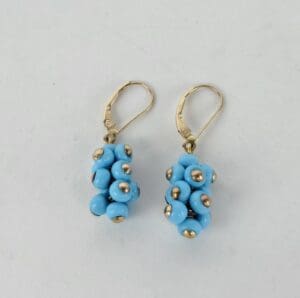 Gold earrings with blue bead clusters.