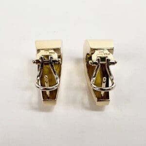 Gold and silver clip-on earrings.