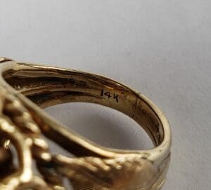 Close-up of a gold ring marked 14K.