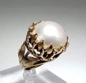 Ornate ring with large pearl centerpiece.