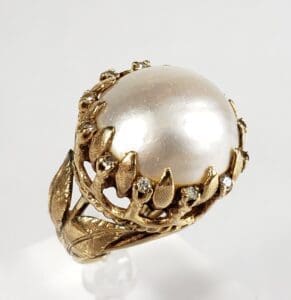 Gold ring with large pearl and diamonds.