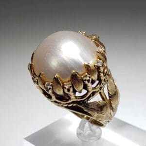 Gold ring with large pearl centerpiece.
