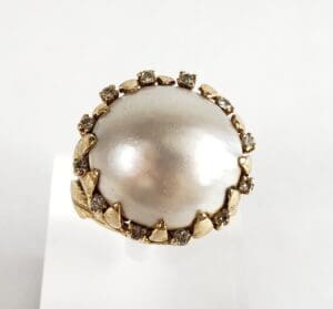 Gold ring with large pearl and diamonds.