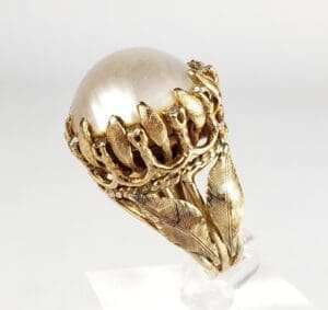 Gold ring with ornate leaf design.