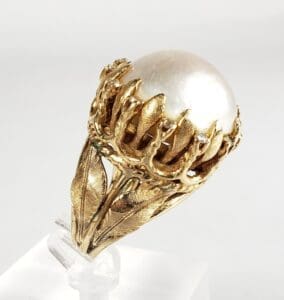 Gold ring with large pearl centerpiece.