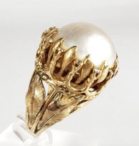 Gold ring with large white pearl.